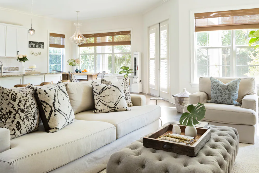 Family room open to kitchen and breakfast area, linen sofa with black and white pillows, at Hyde Park in Tampa. Interior design by MJ Designs